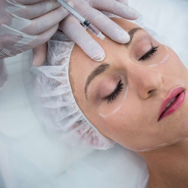 woman-with-marked-face-receiving-botox-injection